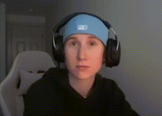 a young boy wearing headphones and a headband is sitting in a chair .