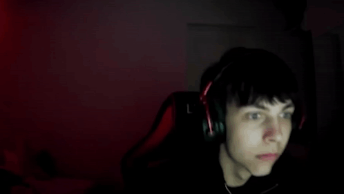 Boy With Headphones Sitting In Front Of Computer GIF