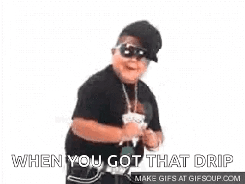 A Young Boy Wearing Sunglasses And A Hat Is Dancing . GIF