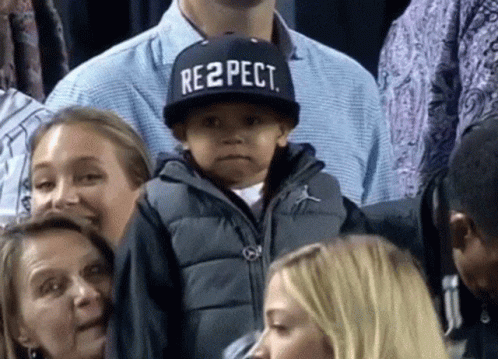 A Young Boy Wears A Hat That Says Respect GIF
