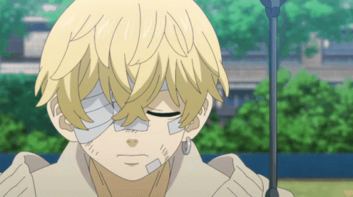 A Young Boy With A Bandage On His Eye Is Looking Down GIF