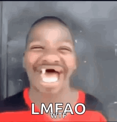 A Young Boy With A Missing Tooth Is Making A Funny Face And Laughing . GIF