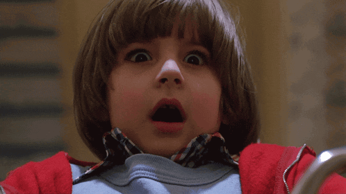 a young boy with a surprised expression on his face