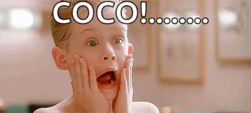A Young Boy With A Surprised Look On His Face Is Holding His Face With His Hands . GIF