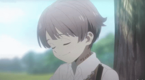 A Young Boy With A Tattoo On His Neck Is Smiling With His Eyes Closed . GIF