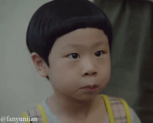 A Young Boy With A Very Short Haircut Is Making A Face GIF