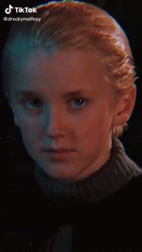 A Young Boy With Blonde Hair And A Nose Ring Is Smiling For The Camera . GIF