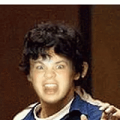 A Young Boy With Curly Hair Is Making A Funny Face With His Mouth Open . GIF