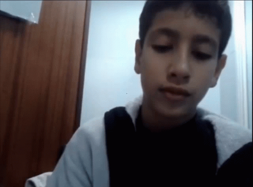 A Young Boy With His Eyes Closed And A Black Shirt On GIF