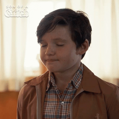 A Young Boy With His Eyes Closed In A Son Of A Griffin Photo GIF