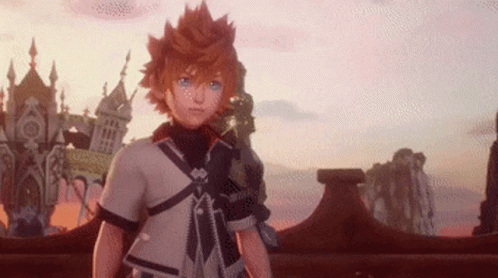 A Young Boy With Orange Hair And Blue Eyes Is Standing In Front Of A Castle In A Video Game . GIF