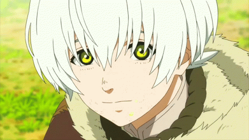A Young Boy With White Hair And Green Eyes Is Looking At The Camera GIF