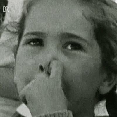 A Young Girl Is Covering Her Nose With Her Hand . GIF