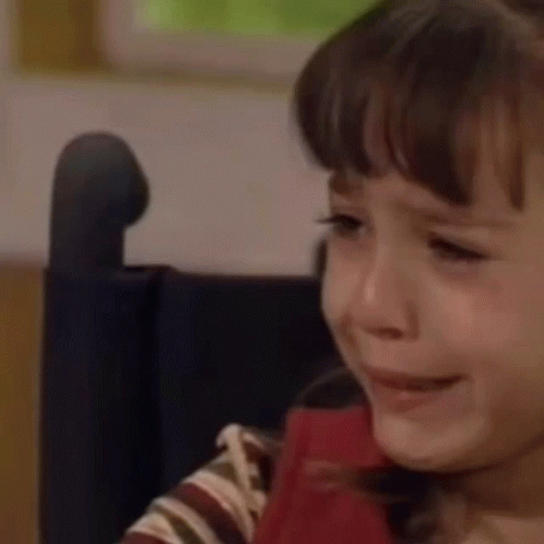 A Young Girl Is Crying In A Wheelchair . GIF