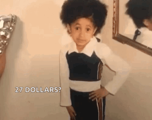 A Young Girl Is Standing In Front Of A Mirror . GIF