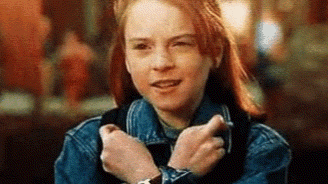 A Young Girl Wearing A Denim Jacket And A Watch Is Making A Funny Face . GIF