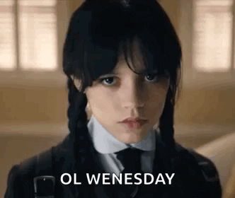 A Young Girl With Braids Is Wearing A School Uniform And A Tie And Says `` Ol Wednesday '' . GIF