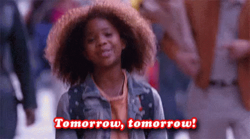 A Young Girl With Curly Hair Is Smiling And Says `` Tomorrow , Tomorrow ! '' . GIF
