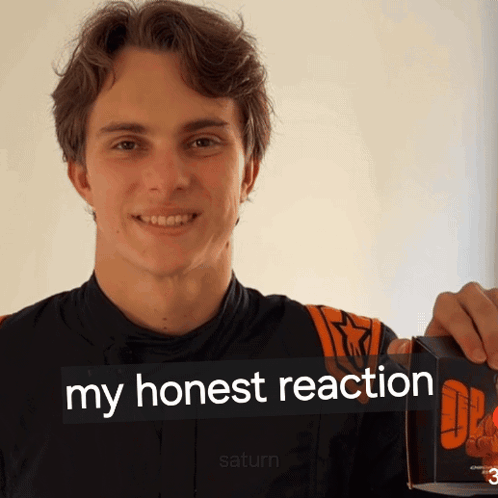A Young Man Holding A Box That Says My Honest Reaction On It GIF