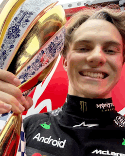 A Young Man Holding A Trophy That Says Android On His Shirt GIF