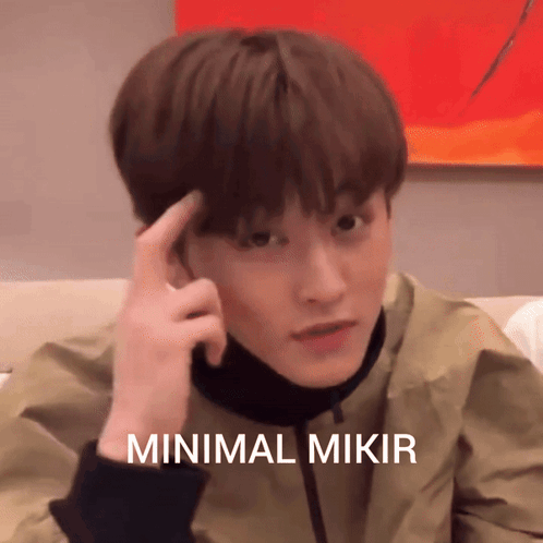 A Young Man Holds His Finger To His Forehead With The Words Minimal Mikir Written Below Him GIF