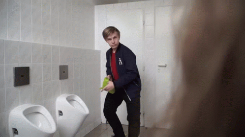 A Young Man In A Blue Jacket With A Sticker On It That Says ' A ' GIF