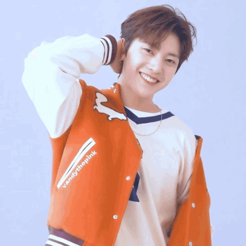 A Young Man In A Blue Shirt Has His Hand On His Forehead GIF