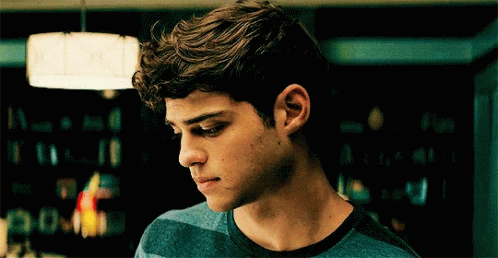 A Young Man In A Blue Striped Shirt Looks Down GIF