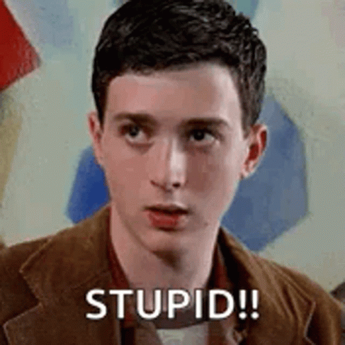 A Young Man In A Brown Jacket Is Looking At The Camera And Saying Stupid . GIF