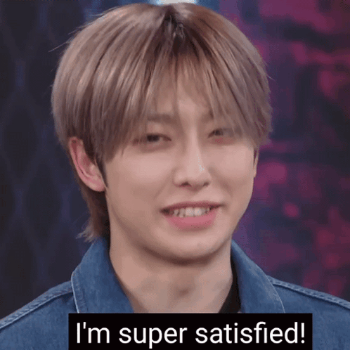 A Young Man In A Denim Jacket Is Smiling With The Words I 'M Super Satisfied Below Him GIF