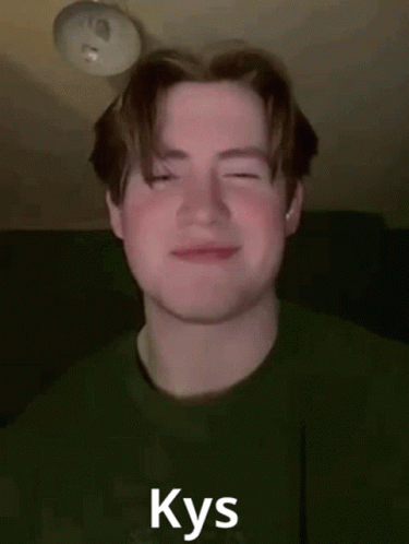 A Young Man In A Green Shirt Is Smiling With His Eyes Closed And The Word Kys Written On His Face . GIF