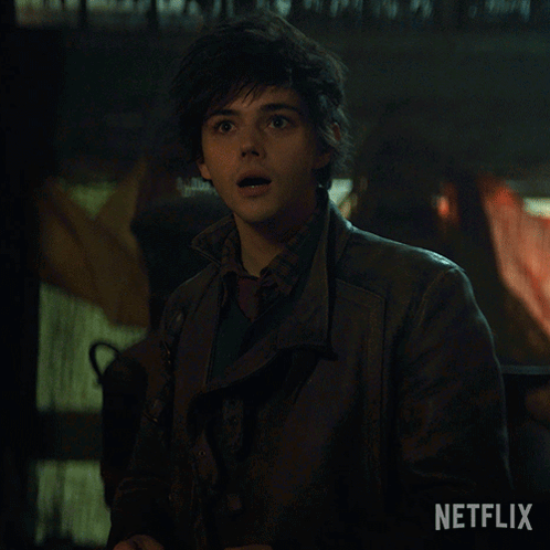 A Young Man In A Leather Jacket Says Hi In A Netflix Ad GIF
