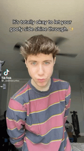 A Young Man In A Pink And Blue Striped Shirt Is Making A Funny Face In A Tik Tok GIF