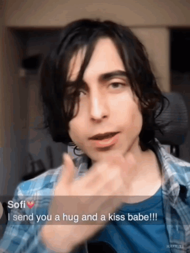 Young Man In Plaid Shirt Sending Hug And Kiss GIF