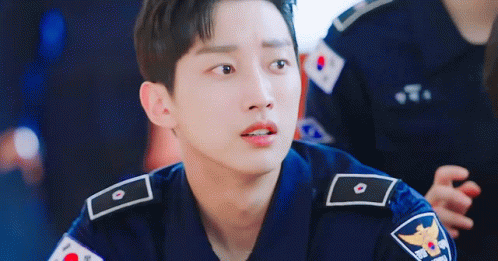 A Young Man In A Police Uniform Is Looking At The Camera With A Sad Look On His Face . GIF