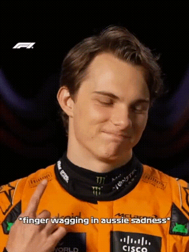 A Young Man In A Racing Suit Is Giving The Middle Finger GIF