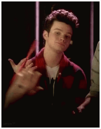 A Young Man In A Red And Black Plaid Shirt Is Making A Funny Face . GIF
