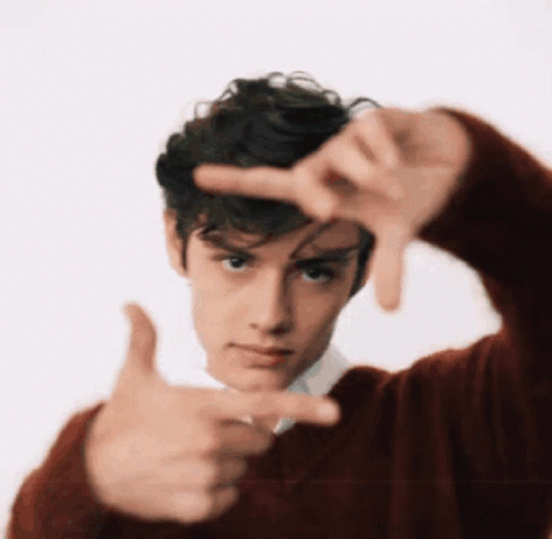 A Young Man In A Red Sweater Making A Frame With His Hands GIF