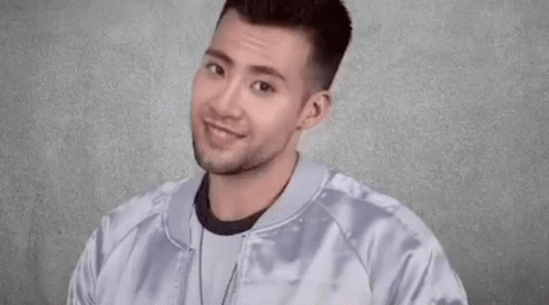 Young Man Smiling And Making Funny Face GIF