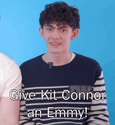 A Young Man In A Striped Shirt Says " Give Kit Connor An Emmy ! " GIF