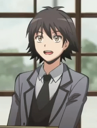 A Young Man In A Suit And Tie Is Sitting In Front Of A Window GIF