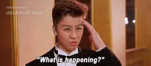 A Young Man In A Tuxedo Is Scratching His Head And Saying `` What Is Happening ? '' . GIF