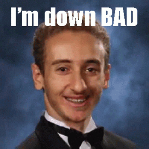 A Young Man In A Tuxedo With The Words I 'M Down Bad Written Above Him GIF