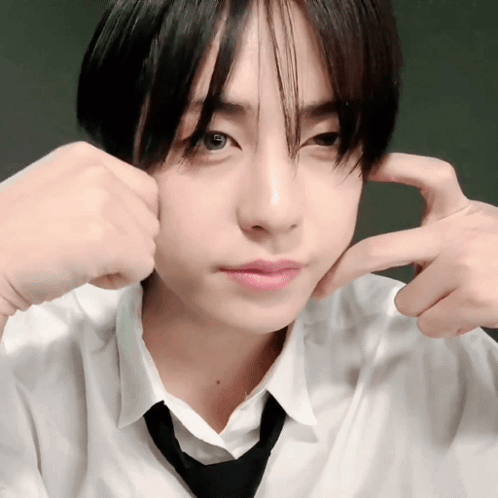 A Young Man In A White Shirt And Black Tie Is Making A Face GIF