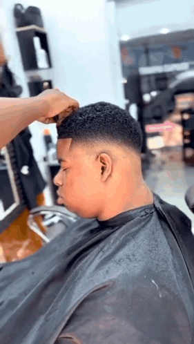 Young Man Getting Haircut At Barber Shop GIF