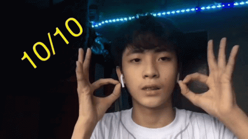 A Young Man Is Giving The Ok Sign With The Number 10 / 10 Behind Him GIF