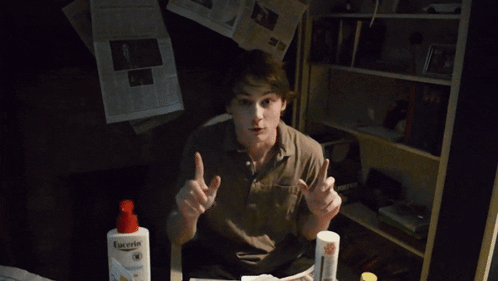 a young man is holding a newspaper that says the new york journal on it