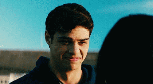 A Young Man Is Looking At A Woman With A Smile On His Face . GIF