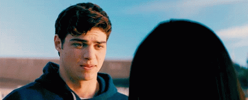 A Young Man Is Looking At A Young Woman . GIF