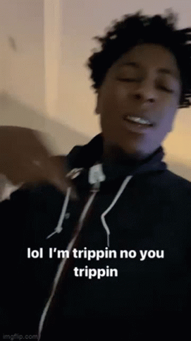 A Young Man Is Making A Funny Face While Wearing A Black Hoodie . GIF